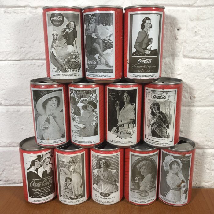 Lot 124: Complete Set of Vintage Coca Cola Cans (No.1-No.12 in a Series of Coca Cola Memorabilia Advertisements)