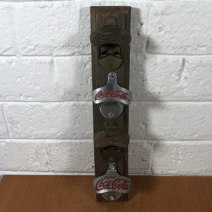 Lot 9: Vintage Coca Cola Bottle Openers Mounted on Wood